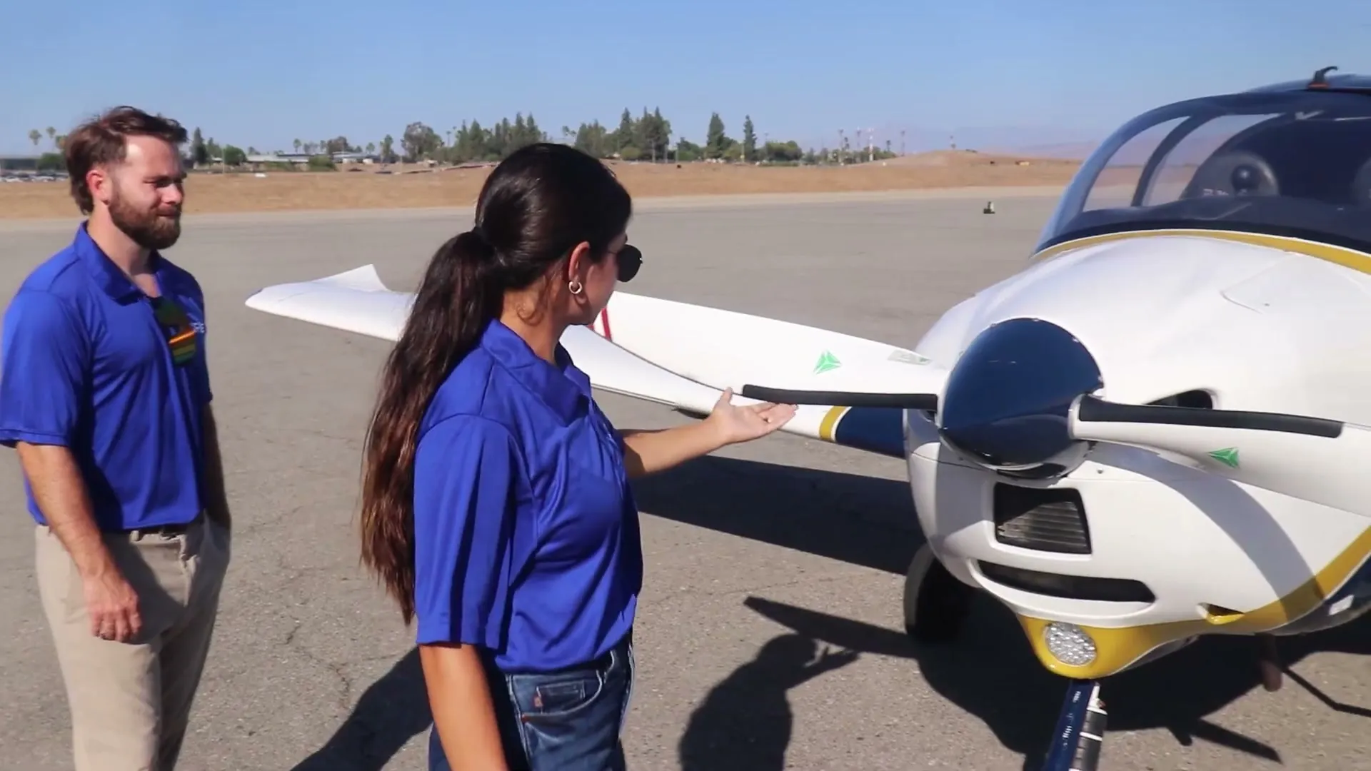 A CFII instructor talking beside a P-Mentor, N906KC, on the ramp