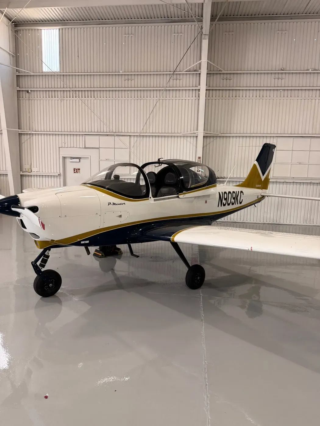 A CFII Tecnam P-Mentor parked in the hangar