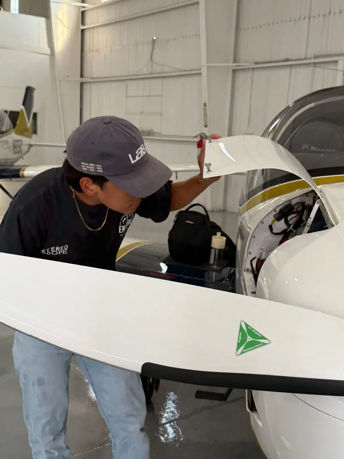 Checking the open engine bay of a Tecnam P-Mentor in our hangar