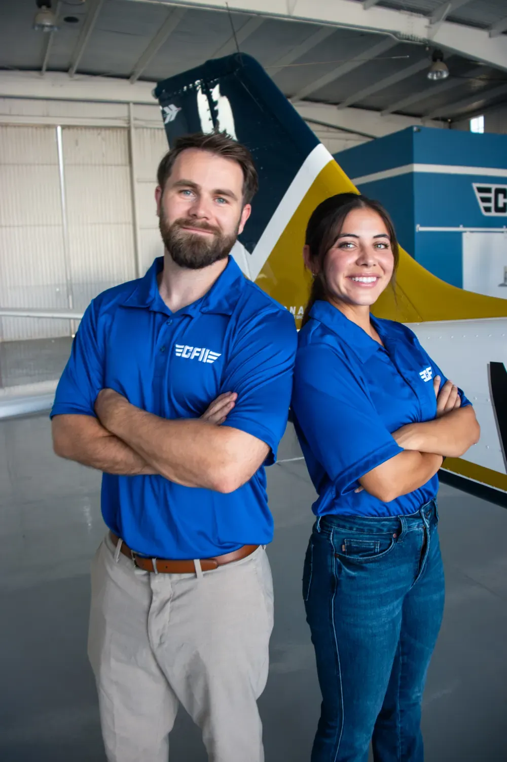 Our team in the hangar in front of a P-Mentor tail