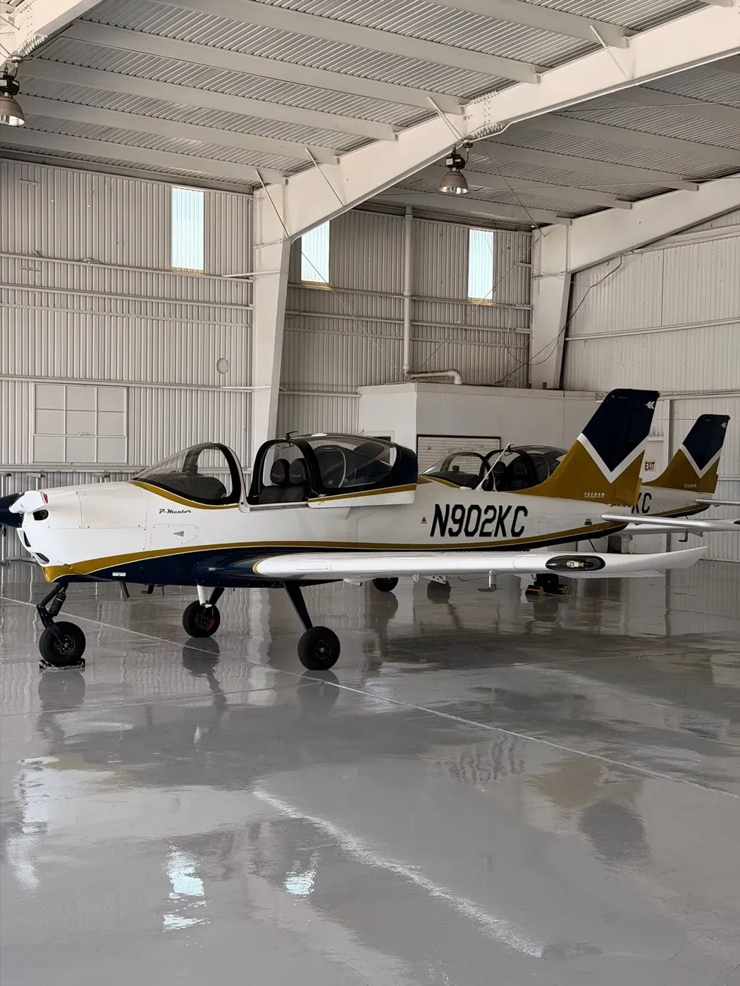 Two CFII P-Mentors parked in the hangar