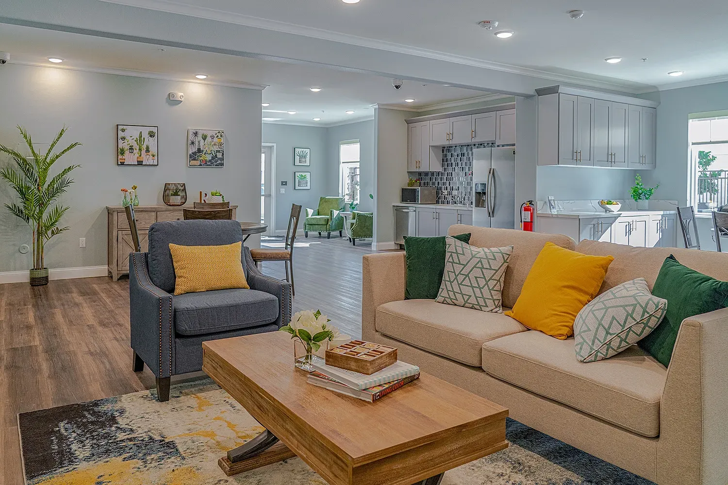 The clubhouse at Turtle Creek: sofas and armchairs in an open lounge next to a full kitchen