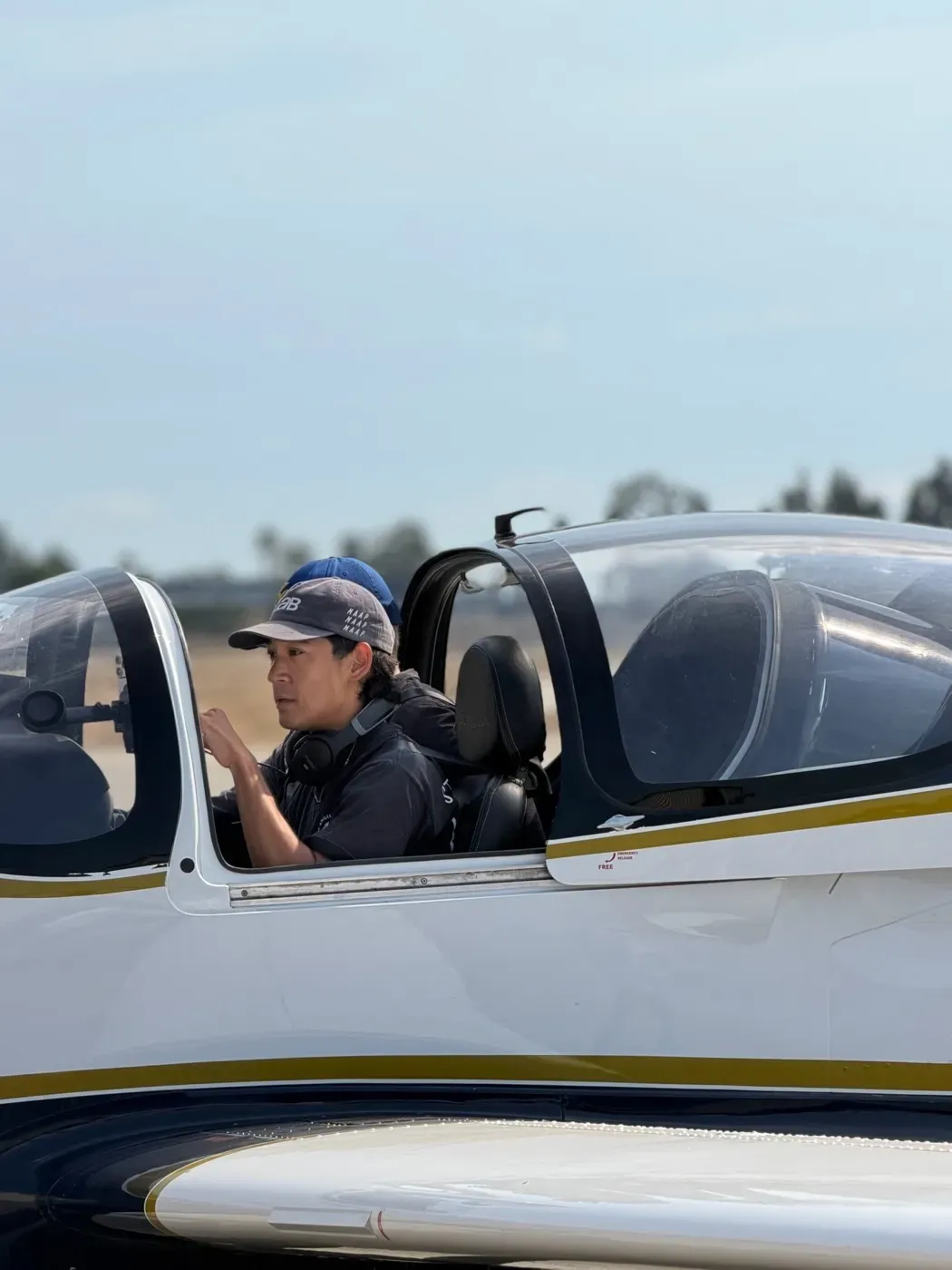 A student in the cockpit of a P-Mentor on the ramp